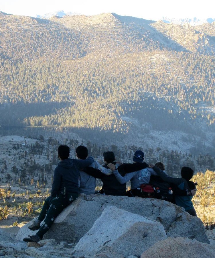 Pyles campers sitting together overlooking the mountains